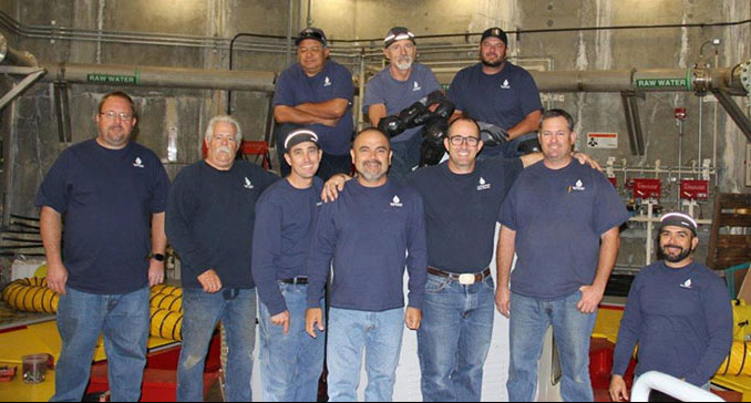 Ten employees pose for a photo inside of the Lake Hodges facility.