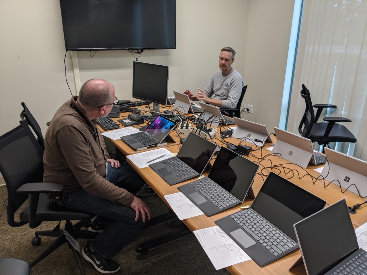  Water Authority staff sit in a conference room with several computers.